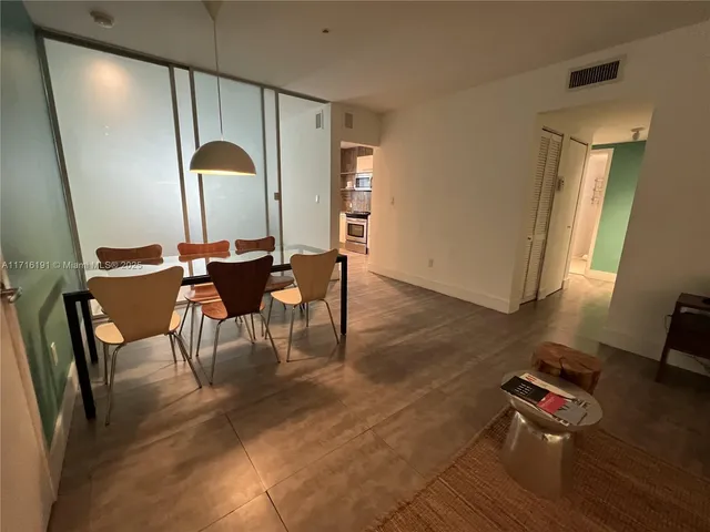 a bedroom with a bed and a large mirror