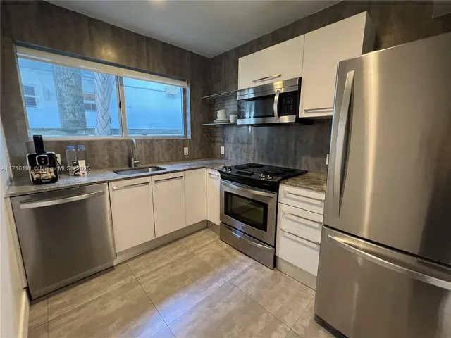 a kitchen with a refrigerator a sink and a stove