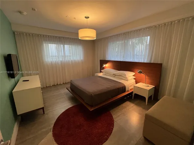 a bedroom with a bed and a chair