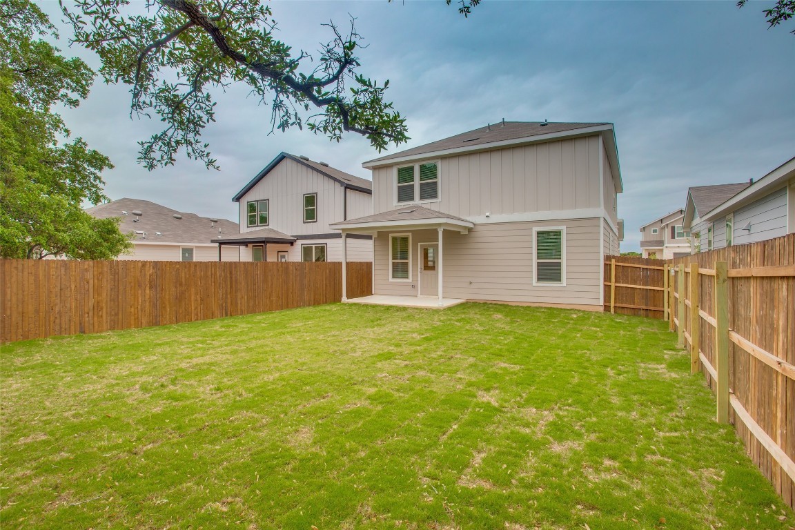 148 Spotted Rail Ridge Leander, TX 78641 - Photo 30 of 31 A spacious backyard with fresh green lawn, ideal for outdoor gatherings and relaxation.