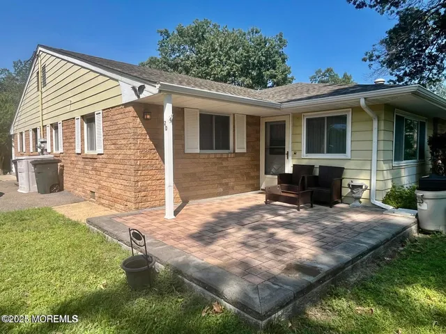 a view of a house with backyard sitting area and porch