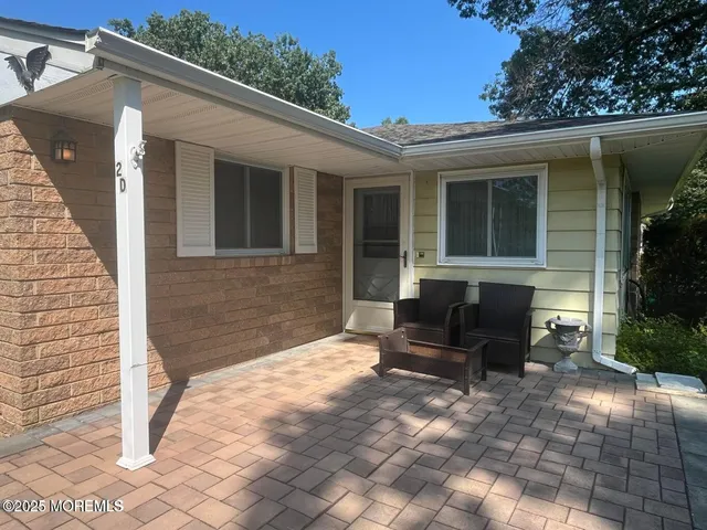 a view of a backyard with sitting area
