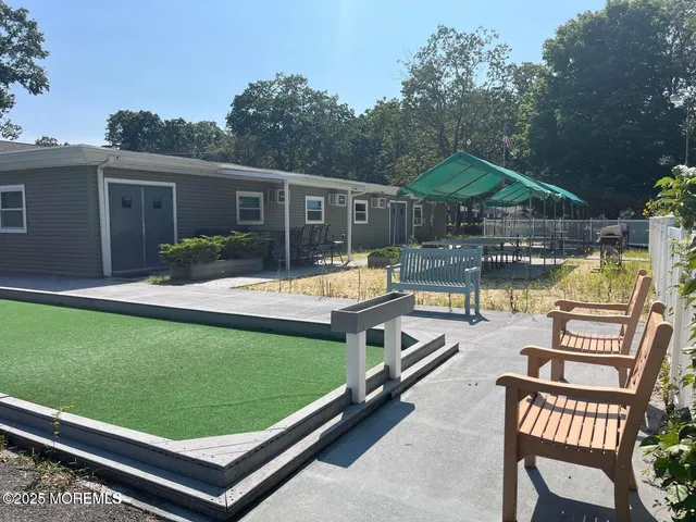a view of a house with a yard and a fountain
