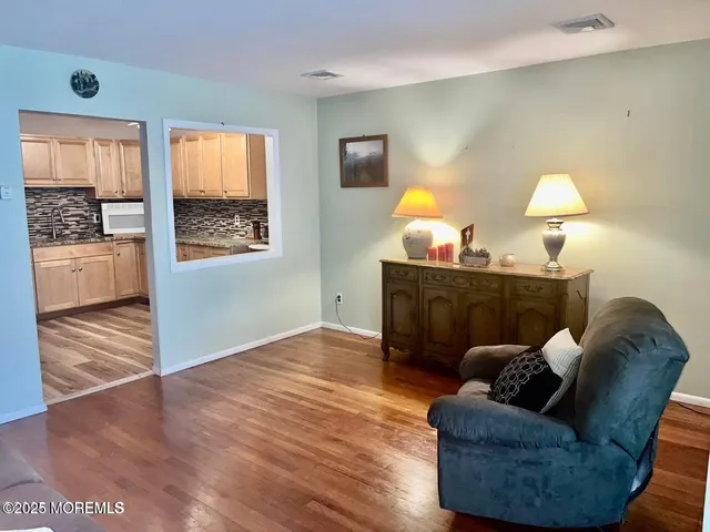 a living room with furniture and a lamp