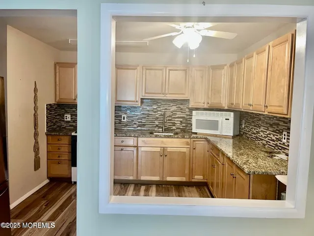 a view of kitchen with furniture and refrigerator