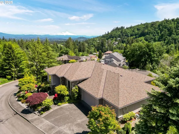 an aerial view of a house with a garden and lots of trees