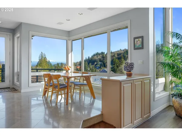 a living room with large windows and a table