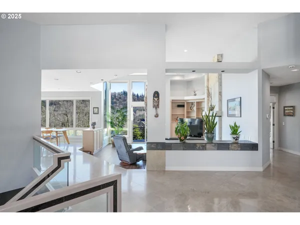 a living room with furniture and potted plants