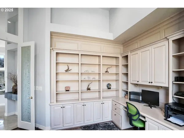 a kitchen with white cabinets and appliances