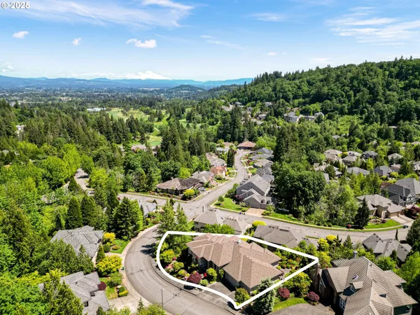an aerial view of a house with a swimming pool