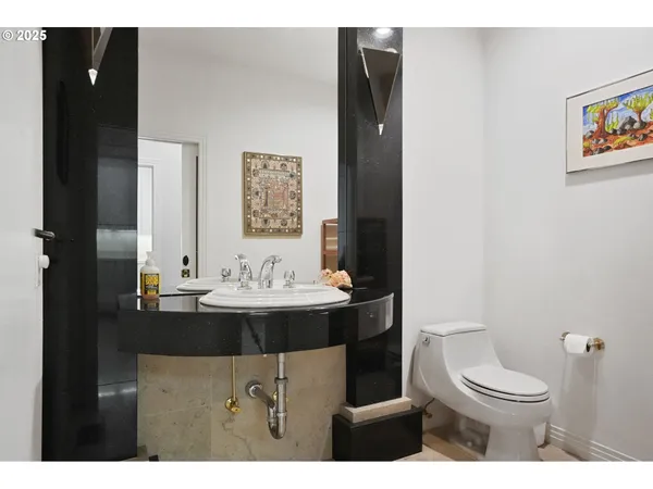 a bathroom with a sink toilet and mirror