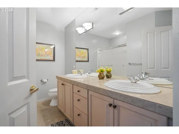 a bathroom with a double vanity sink and a mirror