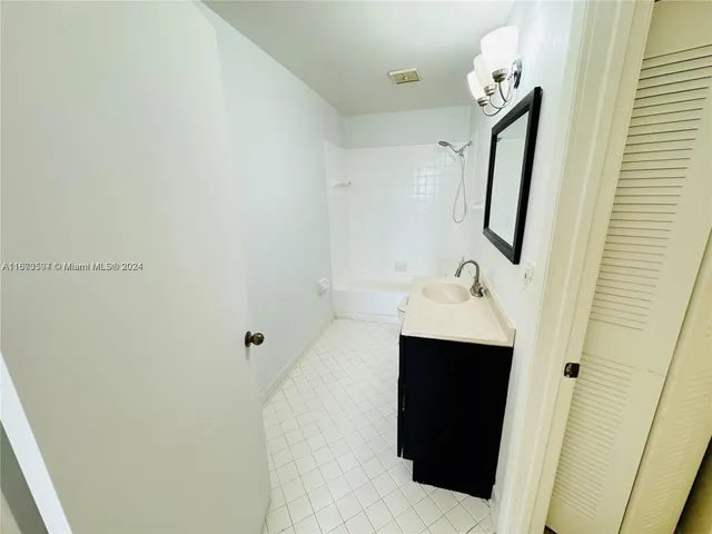 a bathroom with a sink and mirror