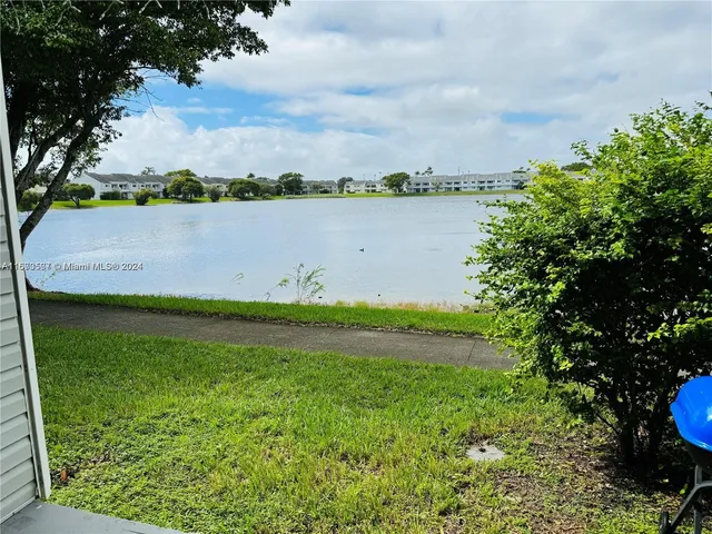 a view of a lake with houses in the back