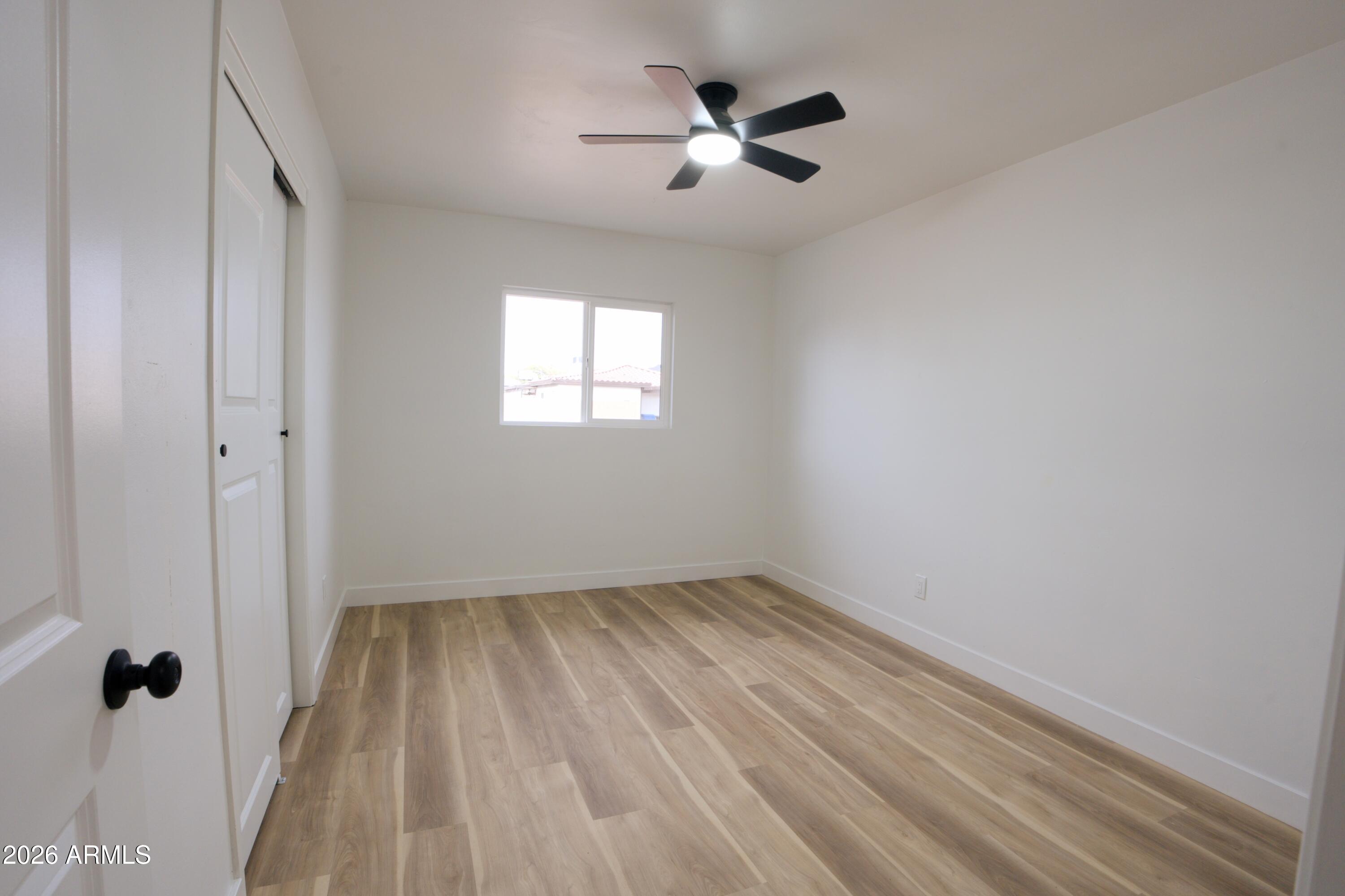 4437 East Almeria Road Phoenix, AZ 85008 - Photo 11 of 20 wooden floor in an empty room with a window