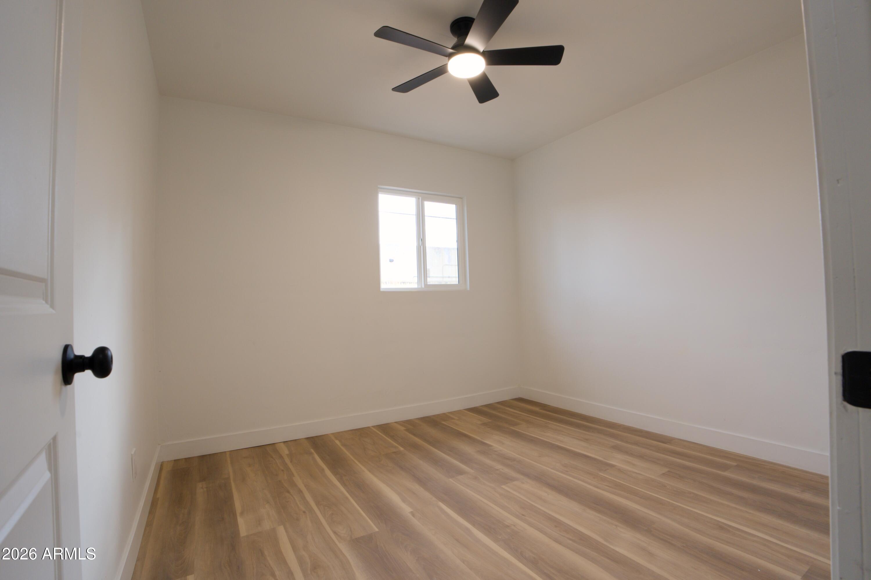4437 East Almeria Road Phoenix, AZ 85008 - Photo 14 of 20 wooden floor in an empty room with a window