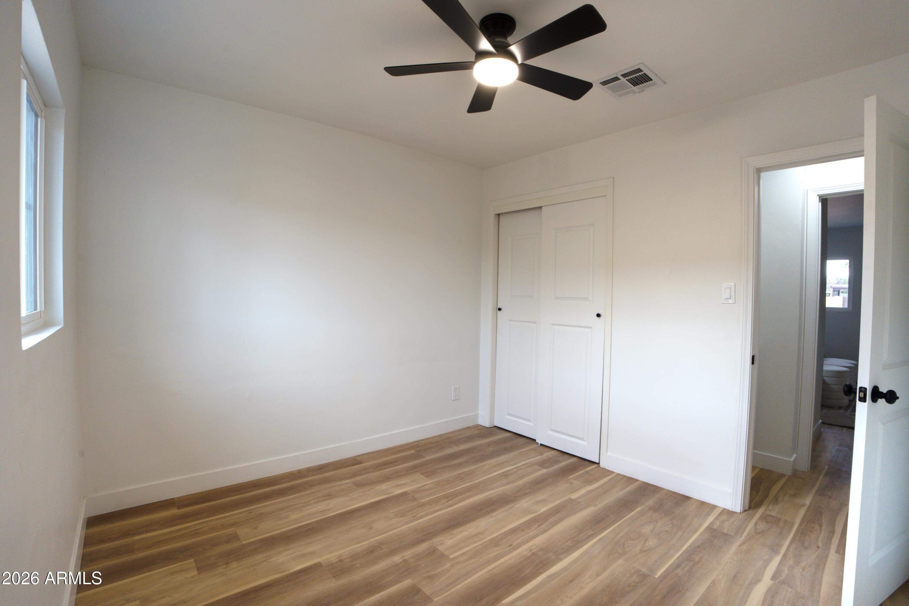 4437 East Almeria Road Phoenix, AZ 85008 - Photo 15 of 20 a view of empty room with wooden floor