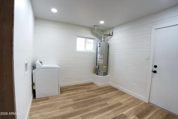 a view of a storage & utility room with a sink