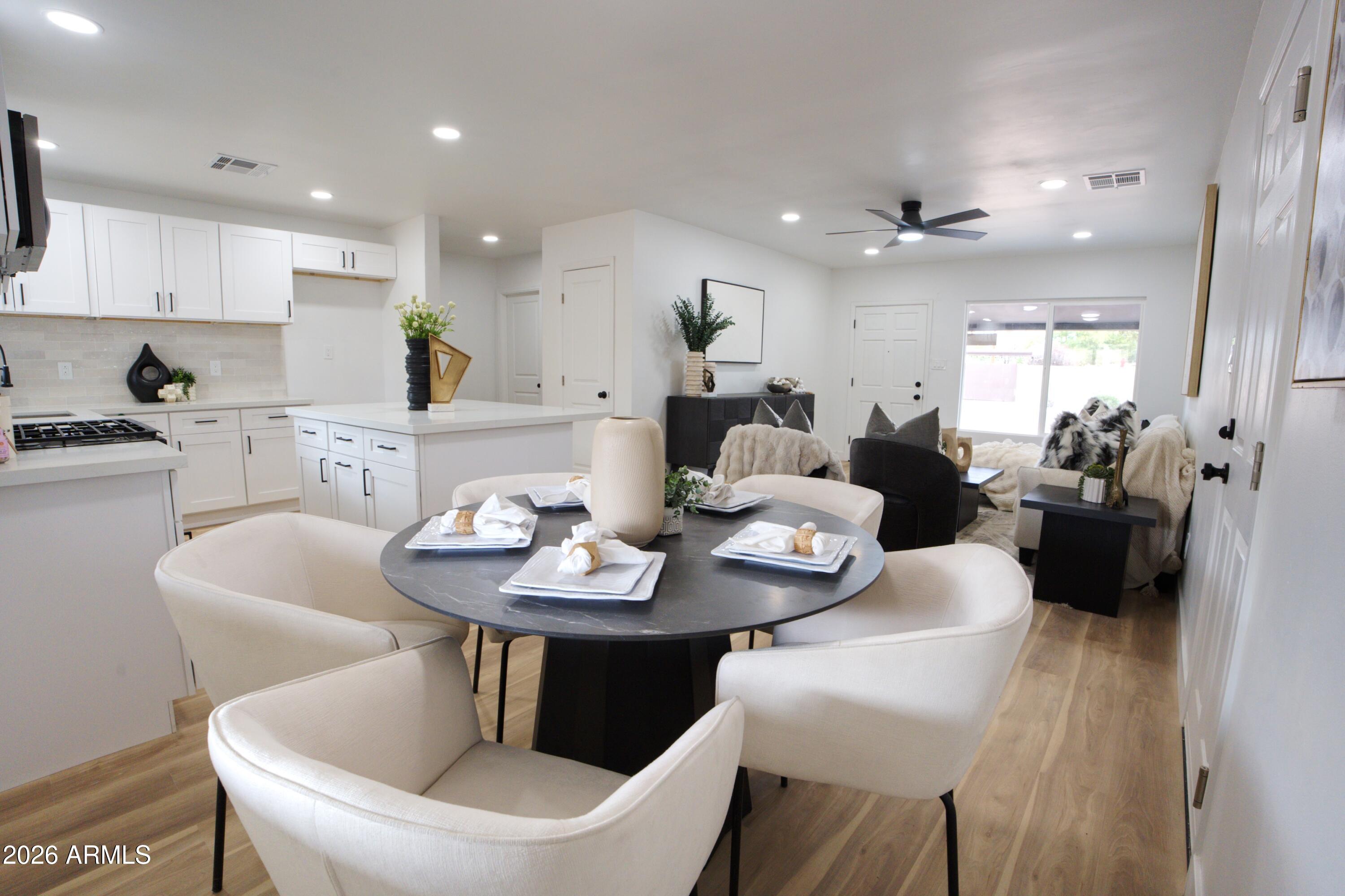 4437 East Almeria Road Phoenix, AZ 85008 - Photo 4 of 20 a view of a dining room with furniture and wooden floor