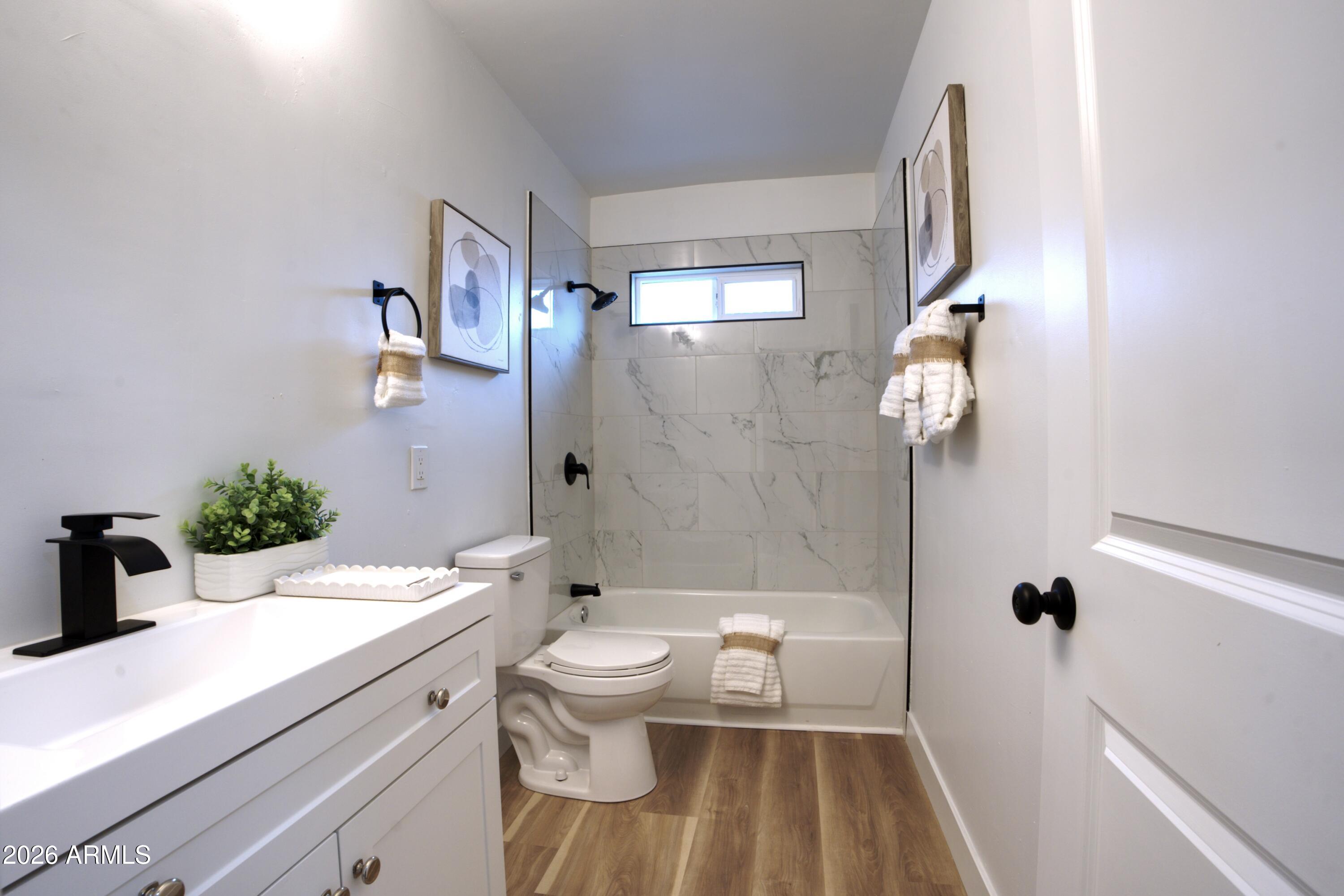 4437 East Almeria Road Phoenix, AZ 85008 - Photo 7 of 20 a bathroom with a sink a toilet and shower