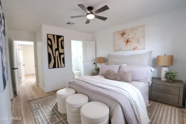 a bedroom with a bed and a painting on the wall