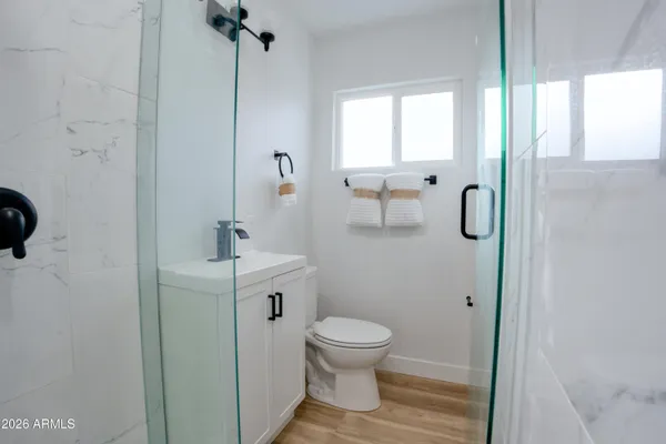 a bathroom with a toilet sink and shower