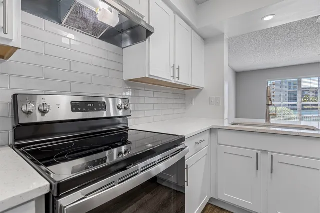 a stove top oven sitting inside of a kitchen