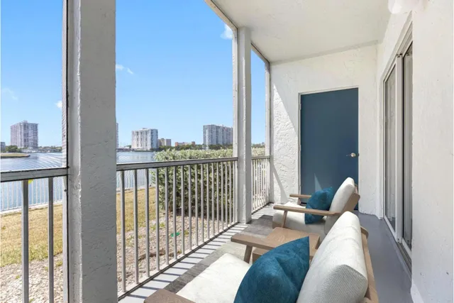 a living room with furniture and a floor to ceiling window