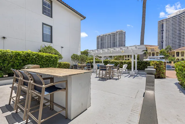 a view of a patio with couches table and chairs and potted plants