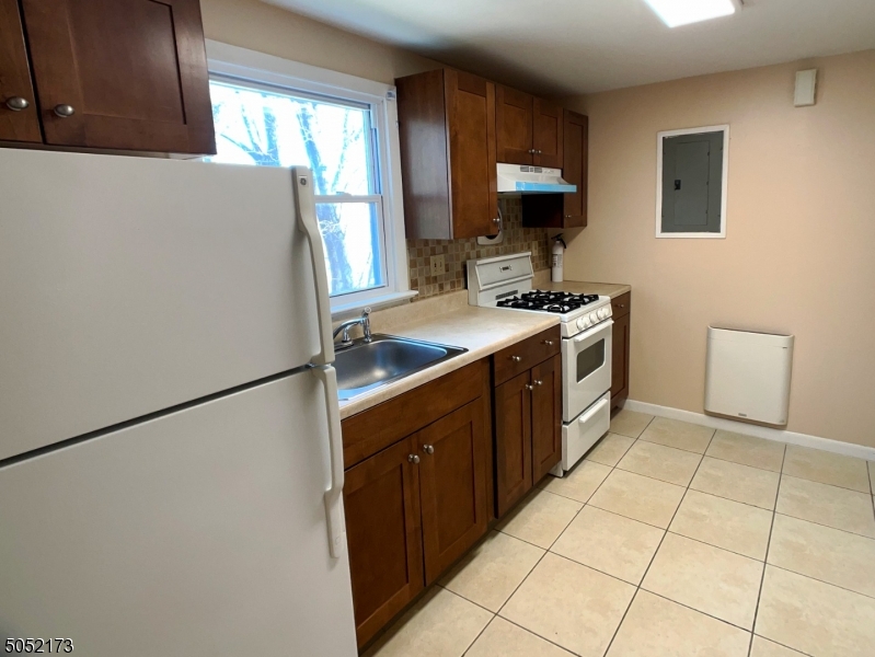 17 Gates Avenue, Unit 3 Montclair, NJ 07042 - Photo 6 of 10 a kitchen with stainless steel appliances granite countertop a sink stove and refrigerator