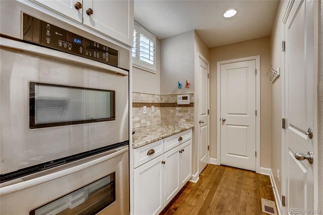 a kitchen with granite countertop cabinets stainless steel appliances and a counter space