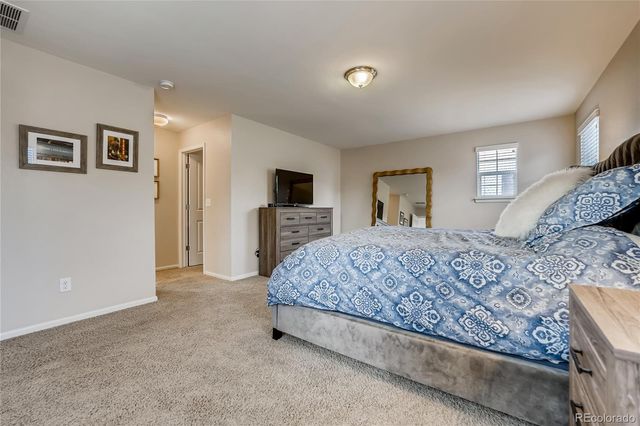 a bedroom with a large bed and a flat screen tv
