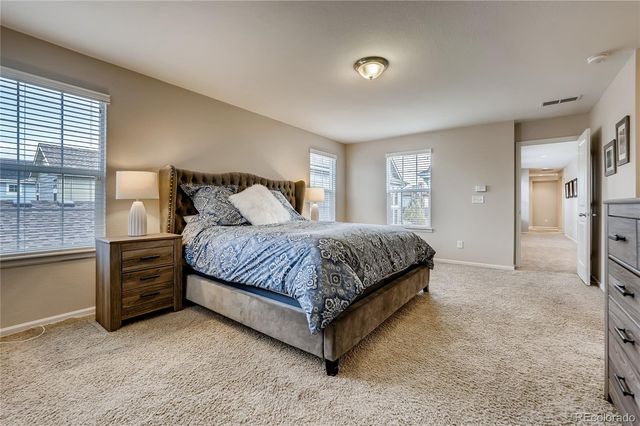 a bedroom with a large bed and a dresser