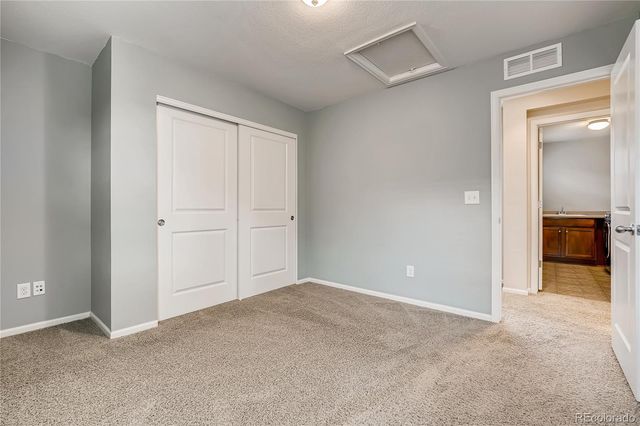 an empty room with closet and bathroom