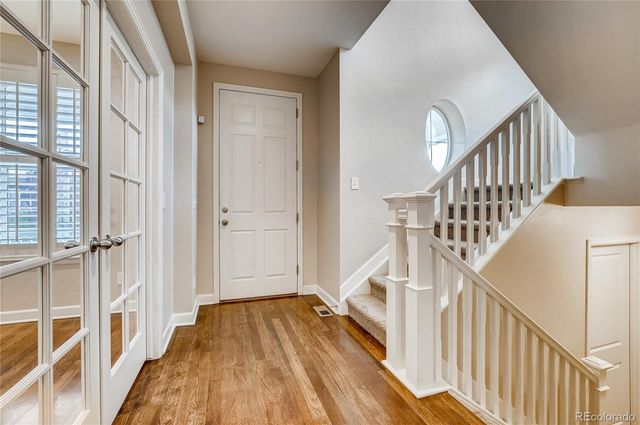 a view of a hallway with wooden floor and entryway