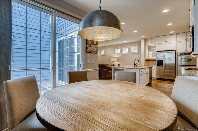 a large kitchen with a table and chairs