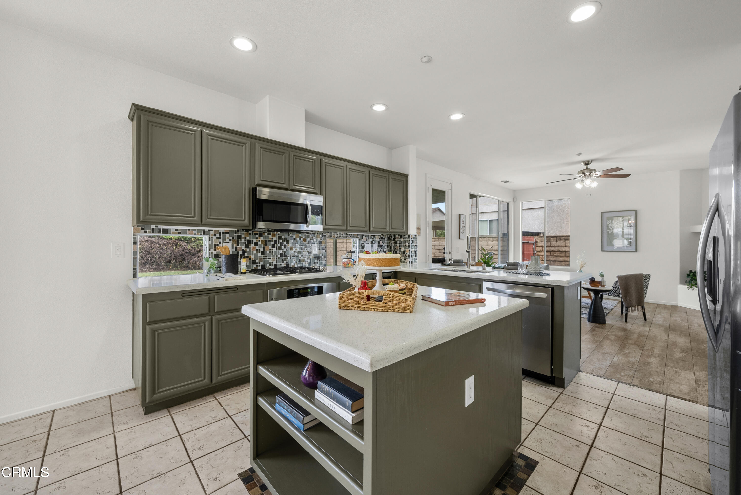 3543 Monte Carlo Drive Oxnard, CA 93035 - Photo 11 of 36 a kitchen with a stove sink and cabinets