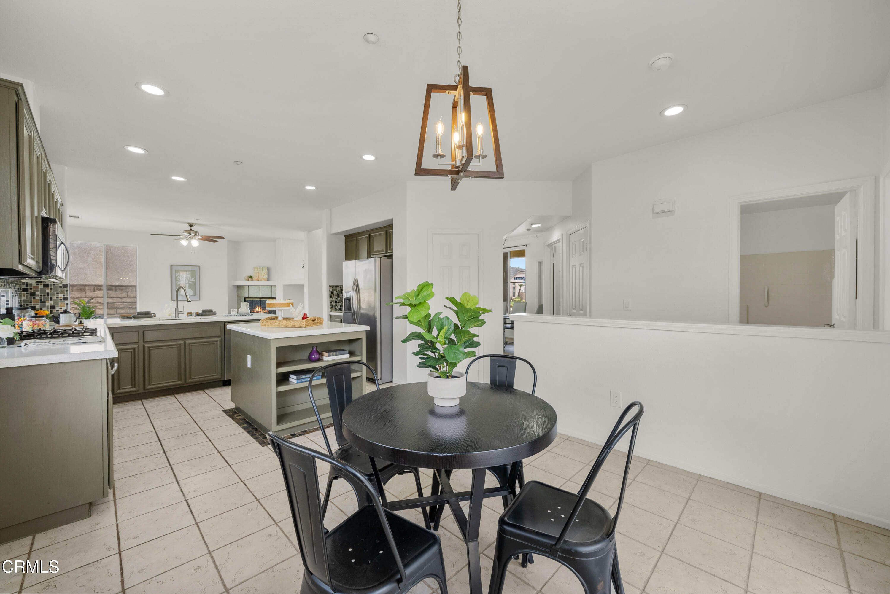 3543 Monte Carlo Drive Oxnard, CA 93035 - Photo 14 of 36 a kitchen with a dining table chairs sink and cabinets