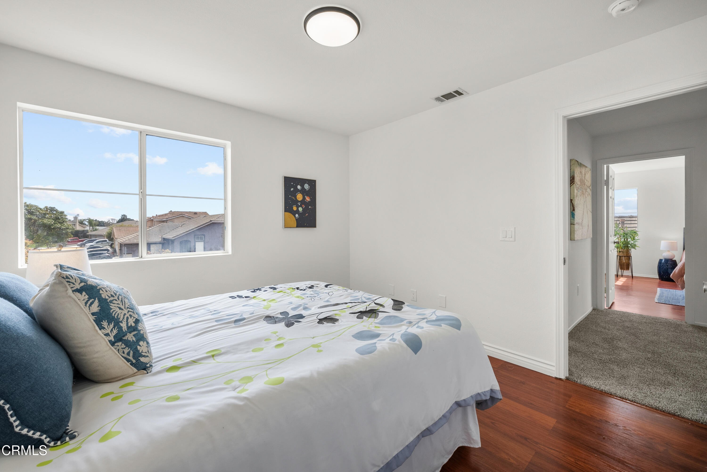 3543 Monte Carlo Drive Oxnard, CA 93035 - Photo 21 of 36 a bedroom with a bed and wooden floor