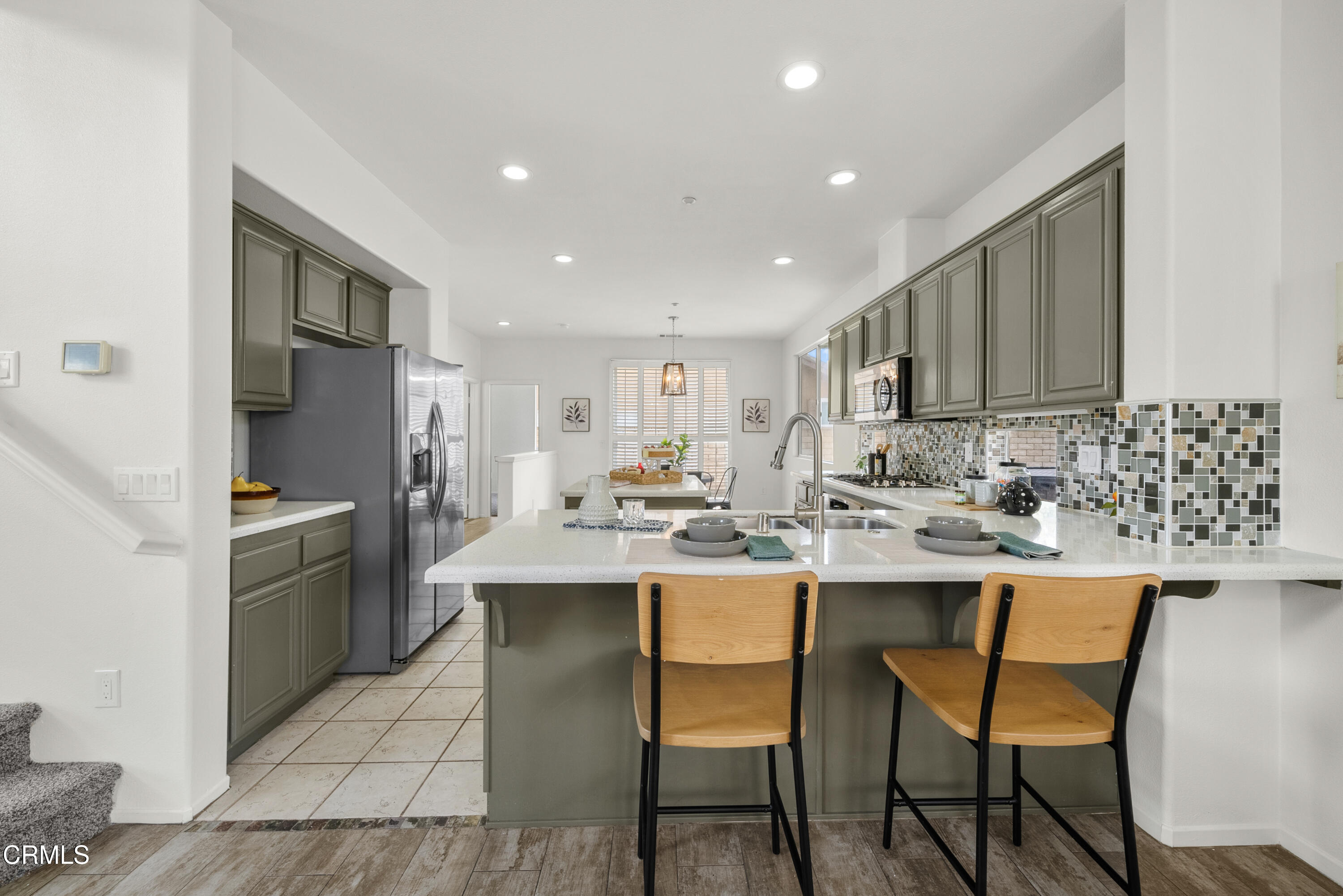 3543 Monte Carlo Drive Oxnard, CA 93035 - Photo 8 of 36 a kitchen with stainless steel appliances kitchen island granite countertop a sink and cabinets