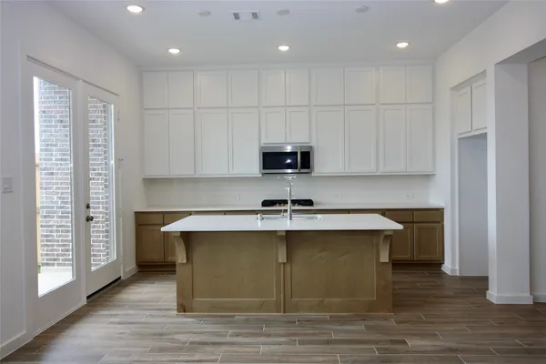 a kitchen with stainless steel appliances granite countertop a sink a stove and a refrigerator