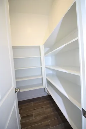 a view of walk in closet with empty racks