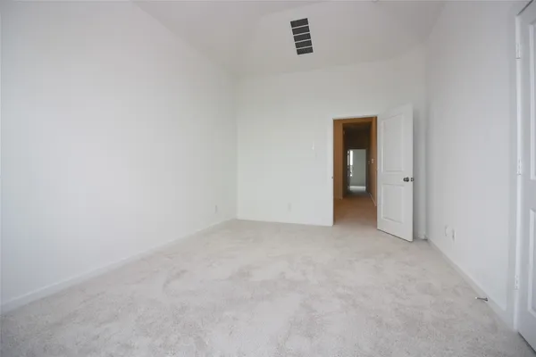 a view of an empty room and a window