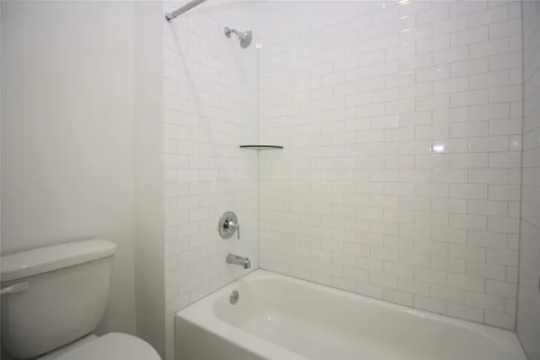 a bathroom with a bathtub and toilet