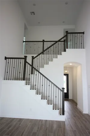 a view of staircase with railing and a floor to ceiling window