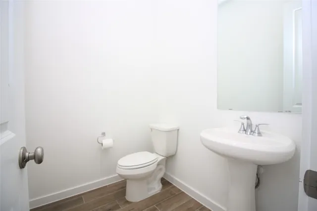 a bathroom with a sink toilet and a mirror