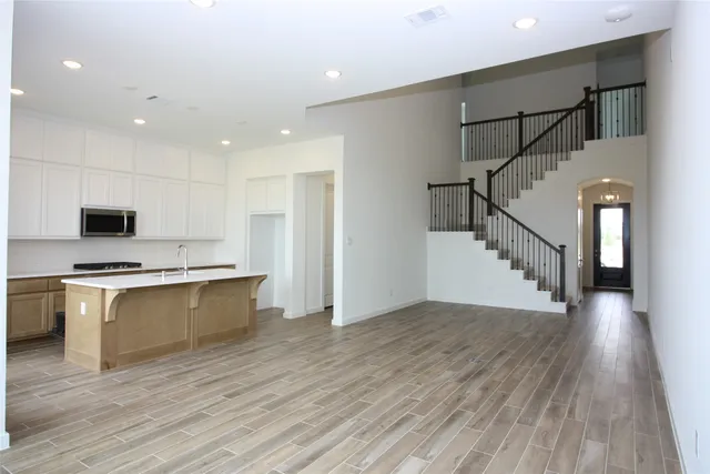 a view of kitchen with sink a microwave and stove