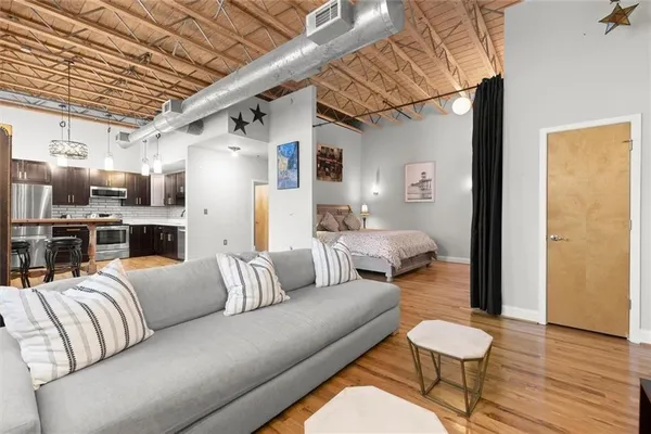 a living room with furniture and a wooden floor