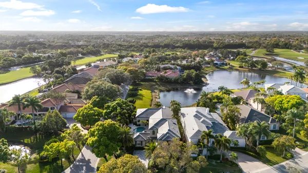 an aerial view of lake and residential houses with outdoor space