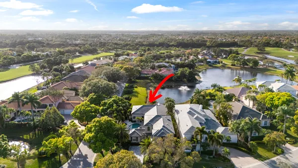 an aerial view of a houses with a lake